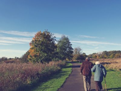 old couple walking on a country lane